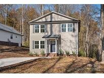 Two-story house with gray siding, a dark gray door and a small front yard at 815 Sherwood Ave, Albemarle, NC 28001