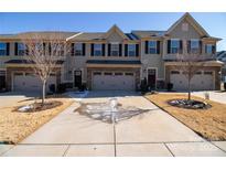 Townhouse exterior with two-car garage and landscaping at 138 Lanyard Dr # B, Mooresville, NC 28117