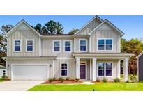 Two-story house with light beige siding, a gray door, and a neatly landscaped lawn at 248 Winford Rd, Troutman, NC 28166