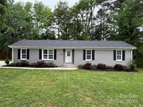 Newly renovated ranch home with gray brick exterior and manicured lawn at 3321 Linda Ct, Rock Hill, SC 29732