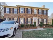 Brick two-story house with a landscaped yard and attached garage at 343 Cottonwood Park Dr, Charlotte, NC 28214