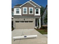 Two-story home with gray siding, stone accents, and a two-car garage at 5626 De Vere Dr, Indian Land, SC 29707