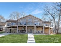 Brick home with large deck and walkway, offering lake views at 8260 Blades Trl, Denver, NC 28037
