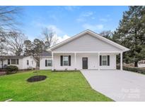 Newly constructed home with gray siding, white trim, and a spacious driveway at 13331 Central Ave, Huntersville, NC 28078