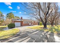 Brick ranch house with attached garage and large yard at 3607 Hickory Hwy, Statesville, NC 28677
