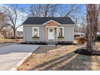 Gray house with wood accents, new driveway, and landscaping at 809 S Bostian St, China Grove, NC 28023