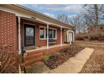 Brick ranch home with covered porch, shed, and landscaping at 927 Ferguson Ridge Rd, Gastonia, NC 28052