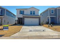 Two-story home with a two-car garage, brick accents and a concrete driveway on a sunny day at 1212 31St Ne St, Conover, NC 28613