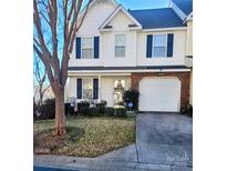 Attractive two-story townhouse with a well-maintained lawn and attached garage at 16740 Timber Crossing Rd, Charlotte, NC 28213