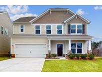 Two-story house with beige and brown siding, a two-car garage, and landscaping at 2125 Clifton Rd, Sherrills Ford, NC 28673