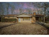 Ranch style home with carport and mature landscaping at 2214 Munsen Rd, Concord, NC 28025