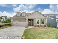 Craftsman style home with two-car garage and stone accents at 4005 Grace Pointe Dr # 100, Wesley Chapel, NC 28079