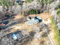 Aerial view of a house with detached sheds and a large yard at 41943 Gurley Rd, New London, NC 28127