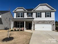 Two-story house with gray siding, stone accents, and a two-car garage at 4479 Dover Ct, Denver, NC 28037