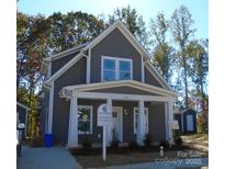 Gray two-story house with white trim and porch at 559 Geneva Cir, Gastonia, NC 28056