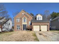 Brick house with two-car garage, and well-maintained landscaping at 5921 Marshbank Ln, Charlotte, NC 28269