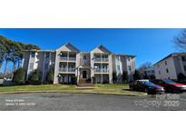 Three-story condo building with multiple units and balconies at 6127 Meadow Rose Ln, Charlotte, NC 28215