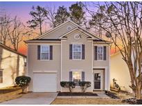 Charming two-story home features a cozy front porch, attached garage, and manicured landscaping at 7010 Sycamore Grove Ct, Charlotte, NC 28227