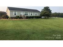 Single-story home with large yard at 7104 Sandy Smith Rd, Marshville, NC 28103