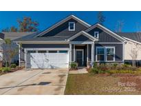 Gray exterior with white garage door and landscaping at 7163 Yardley St, Gastonia, NC 28056