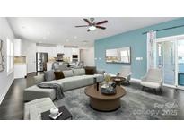 Bright, open-concept living room featuring a modern kitchen, sleek furniture, and stylish decor at 8243 Bretton Woods Dr, Charlotte, NC 28227