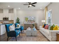 Bright living room features comfy seating, large windows, and a modern aesthetic at 8625 Miles Gap Rd, Indian Land, SC 29707