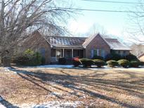 Brick ranch house with a covered porch and landscaped yard at 110 Robin Rd, Lincolnton, NC 28092