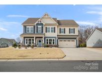 Two-story house with blue and beige siding, a two-car garage, and landscaping at 1503 Brooksland Pl, Waxhaw, NC 28173