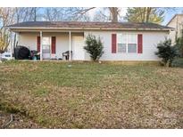 Ranch style home with covered porch and a small yard at 225 American Dr, Salisbury, NC 28147