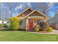 Craftsman style home with red door, landscaping, and a well-maintained lawn at 2328 Barry St, Charlotte, NC 28205