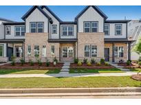 New construction townhome featuring brick accents, well-manicured lawn, and inviting walkway at 3113 Beacon Heights Rd, Indian Land, SC 29707