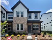 Charming townhome featuring a brick and siding facade, complemented by manicured landscaping and a welcoming entryway at 3113 Beacon Heights Rd, Indian Land, SC 29707