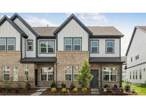 Inviting townhome with brick and siding, featuring a well-manicured lawn and charming curb appeal at 3113 Beacon Heights Rd, Indian Land, SC 29707