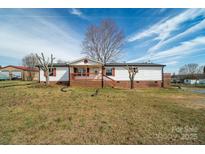 Charming single-story home with white siding, red shutters, and a welcoming front porch at 3416 Polkville Rd, Shelby, NC 28150