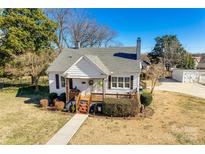 Charming white house with a porch, landscaping, and driveway at 419 Williamson St, Fort Mill, SC 29715