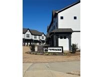 Modern two-story townhome with gray and white exterior and landscaping at 8928 Morning Mist Rd, Charlotte, NC 28215