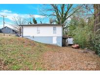 White house back with a small deck and a grassy backyard at 911 Elm St, Kannapolis, NC 28081