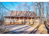 Rustic log cabin home with wraparound porch and large yard at 148 Shawver Ln, Statesville, NC 28625