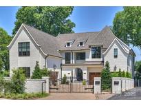 Stunning two-story home with white brick exterior, gated entry, and landscaping at 2714 Selwyn Ave, Charlotte, NC 28209