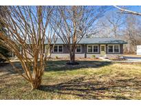 Newly renovated home with a brick facade and well-maintained lawn at 322 Timber Rd, Iron Station, NC 28080