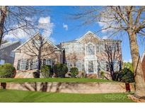 Brick two-story home with landscaped yard and stone wall at 3405 Taviston Dr, Waxhaw, NC 28173