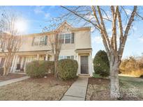 Beige townhome with dark door, landscaping, and walkway at 415 Kilberry Ln, Fort Mill, SC 29715