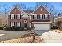 Brick two-story house with a large front yard and attached two-car garage at 6700 Fairhope Ct, Charlotte, NC 28277