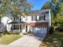 Two-story house with brick and siding, two-car garage, and front porch at 6706 Blackwood Ln, Waxhaw, NC 28173