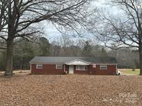 Brick ranch house with a large yard and mature trees at 10704 Connell Rd, Mint Hill, NC 28227