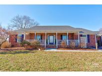 Brick ranch house with front porch, landscaped yard, and a spacious lawn at 116 Country Creek Dr, Kings Mountain, NC 28086