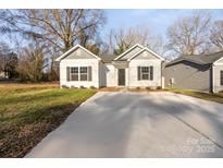 Newly built home with gray and white exterior, a driveway, and landscaping at 1420 Beechwood Dr, Gastonia, NC 28052