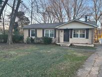 Brick ranch house with a spacious lawn and mature trees at 1500 Collier Ct, Charlotte, NC 28205