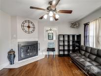 Cozy living room with hardwood floors, fireplace, and unique decor at 1500 Collier Ct, Charlotte, NC 28205