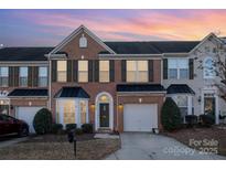 Brick front two-story townhome with attached garage and landscaping at 159 Kallie Loop, Mooresville, NC 28117